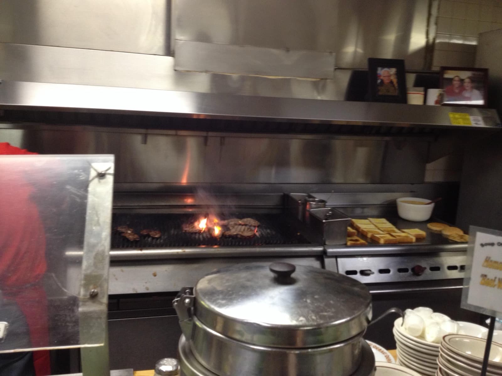 Flames rising from steaks on the open grill