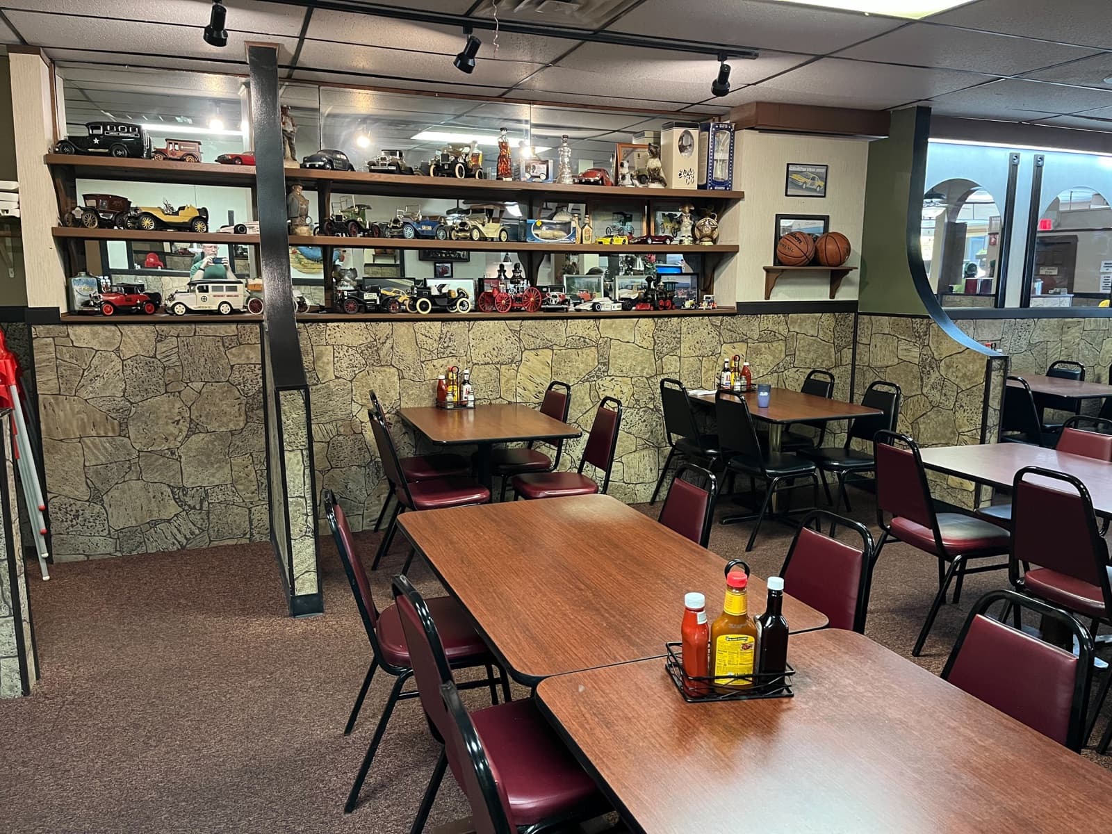 Dining room with vintage toy car memorabilia on the shelves
