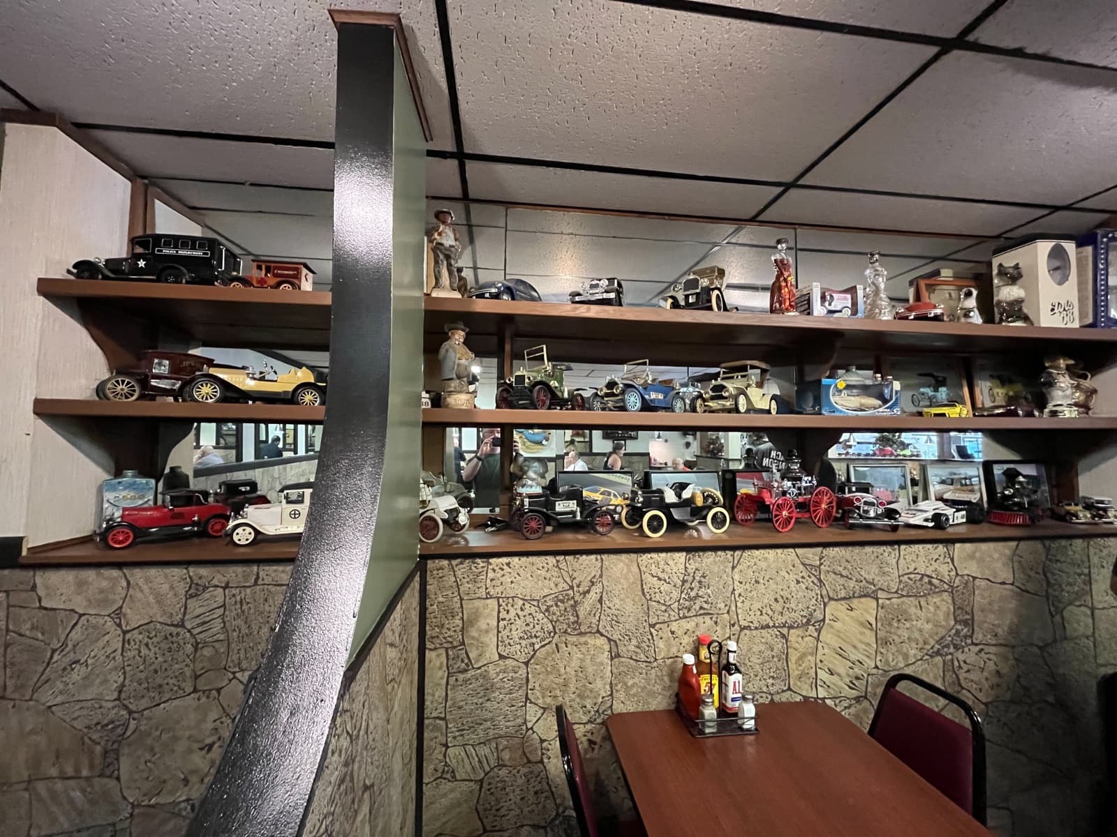 Vintage car memorabilia on shelves above the dining room